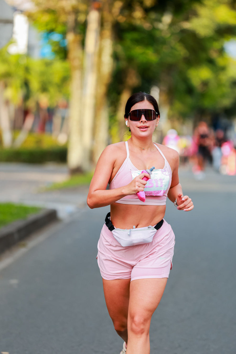 Woman jogging outdoors in pink activewear