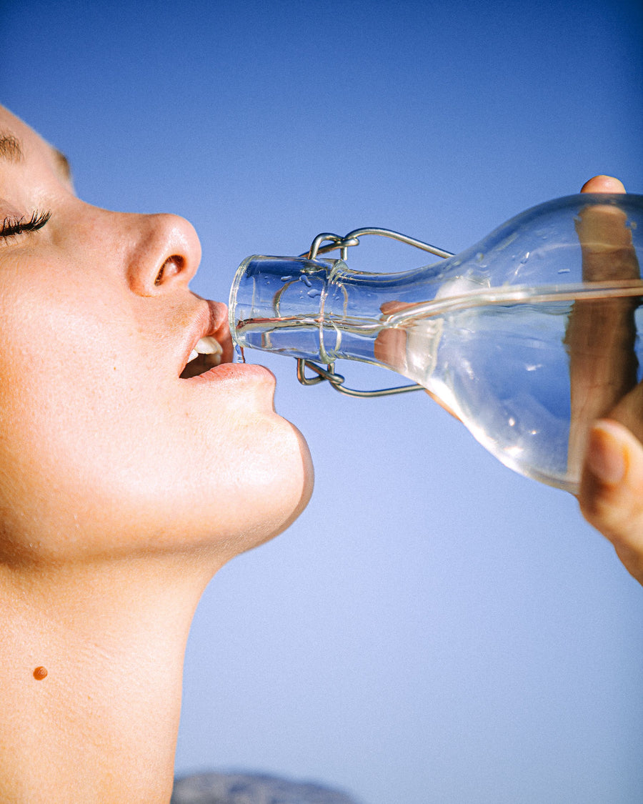 Woman drinking water outdoors