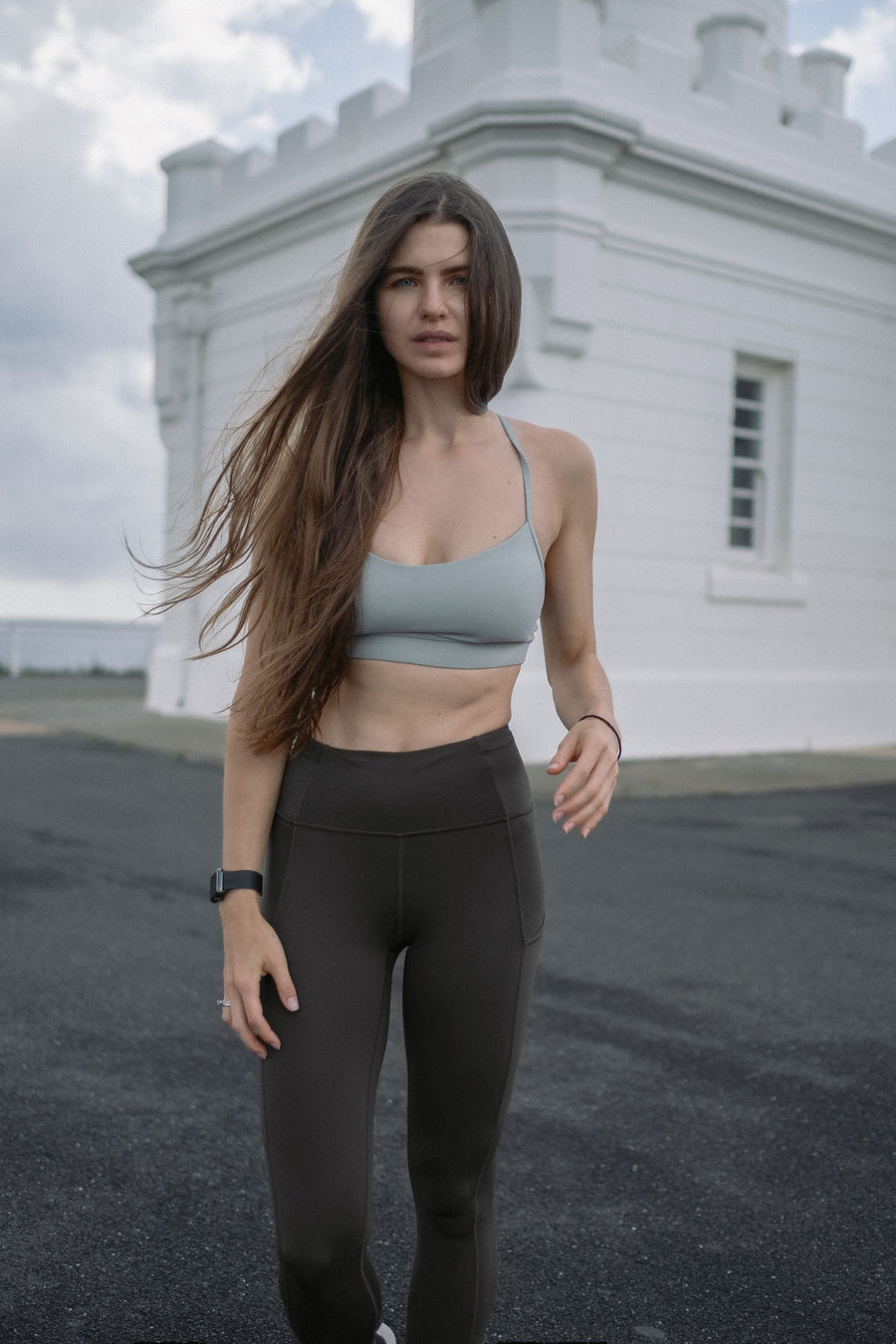 Woman jogging outdoors in gray activewear